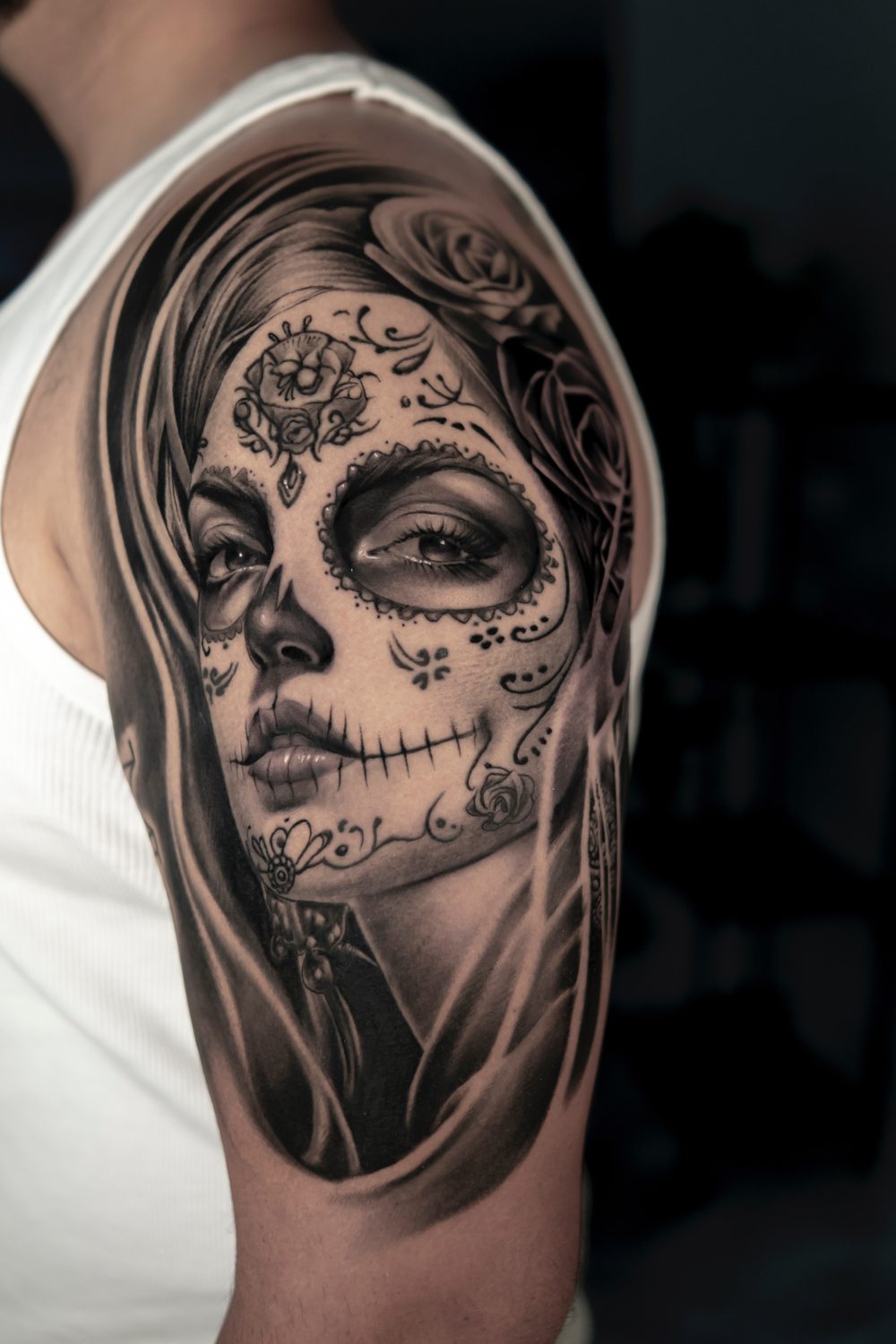 Black and grey Catrina Day of the Dead tattoo on an upper arm