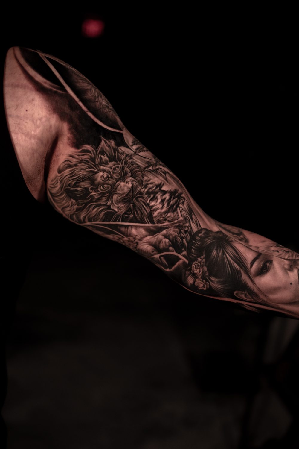 Black and grey lion and geisha sleeve tattoo