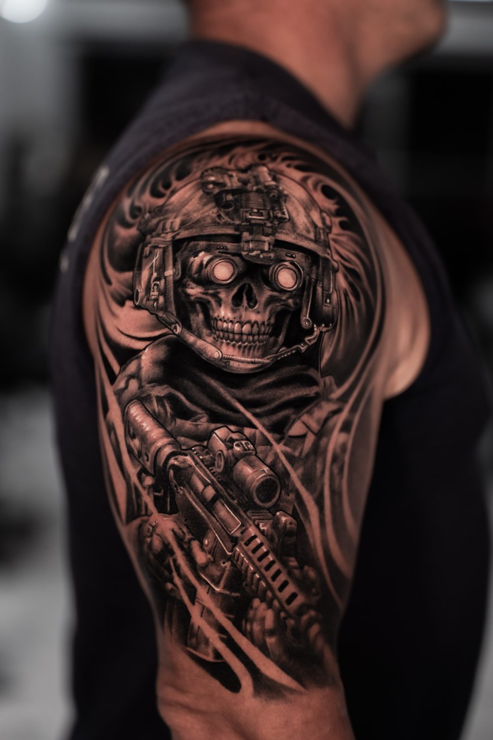 Black and grey military skull tattoo on an upper arm