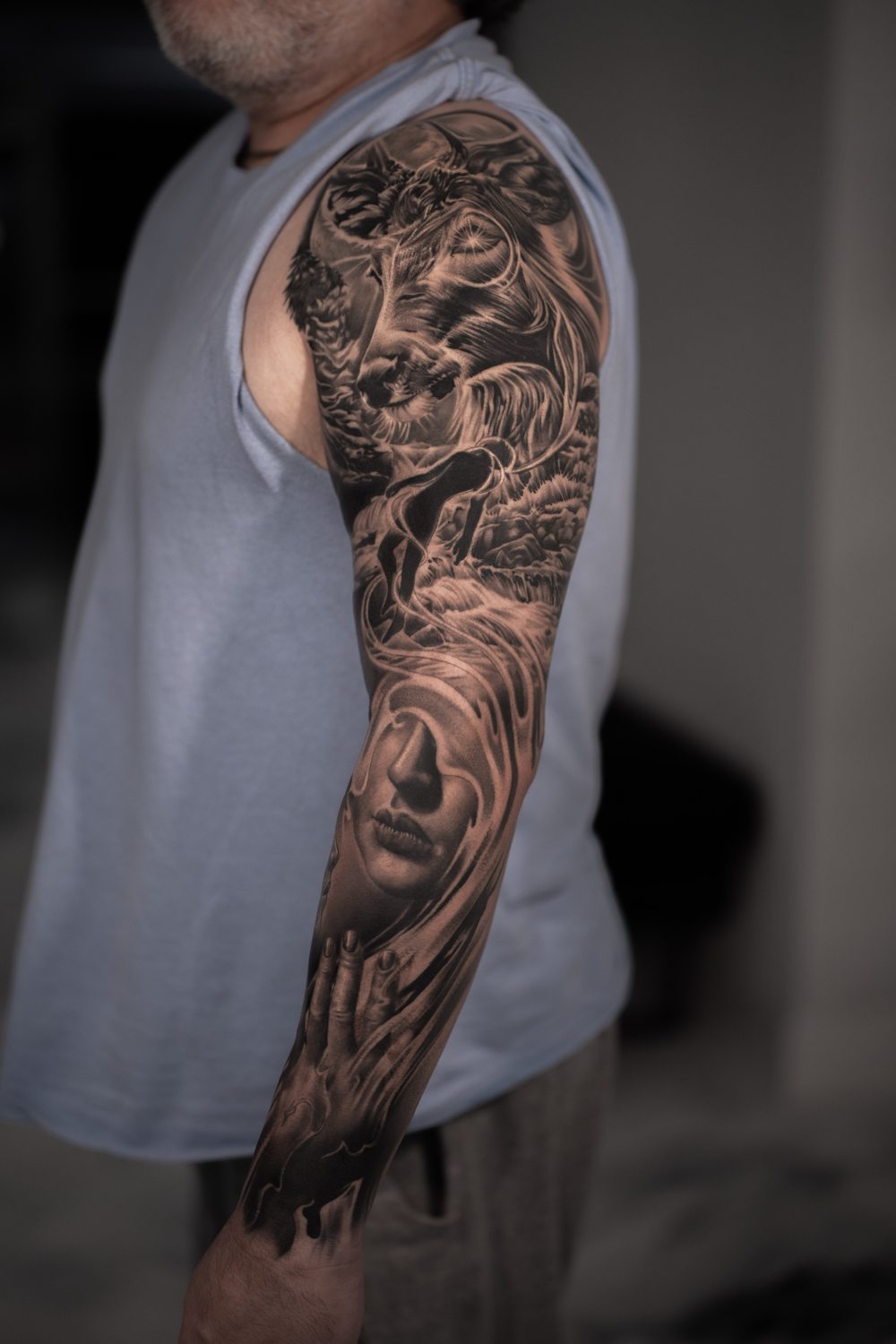 Black and grey portrait and waterfall full sleeve tattoo